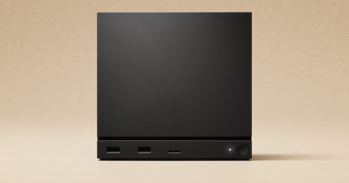 Steam Machine console, a black cube shaped gaming PC, on a warm beige background